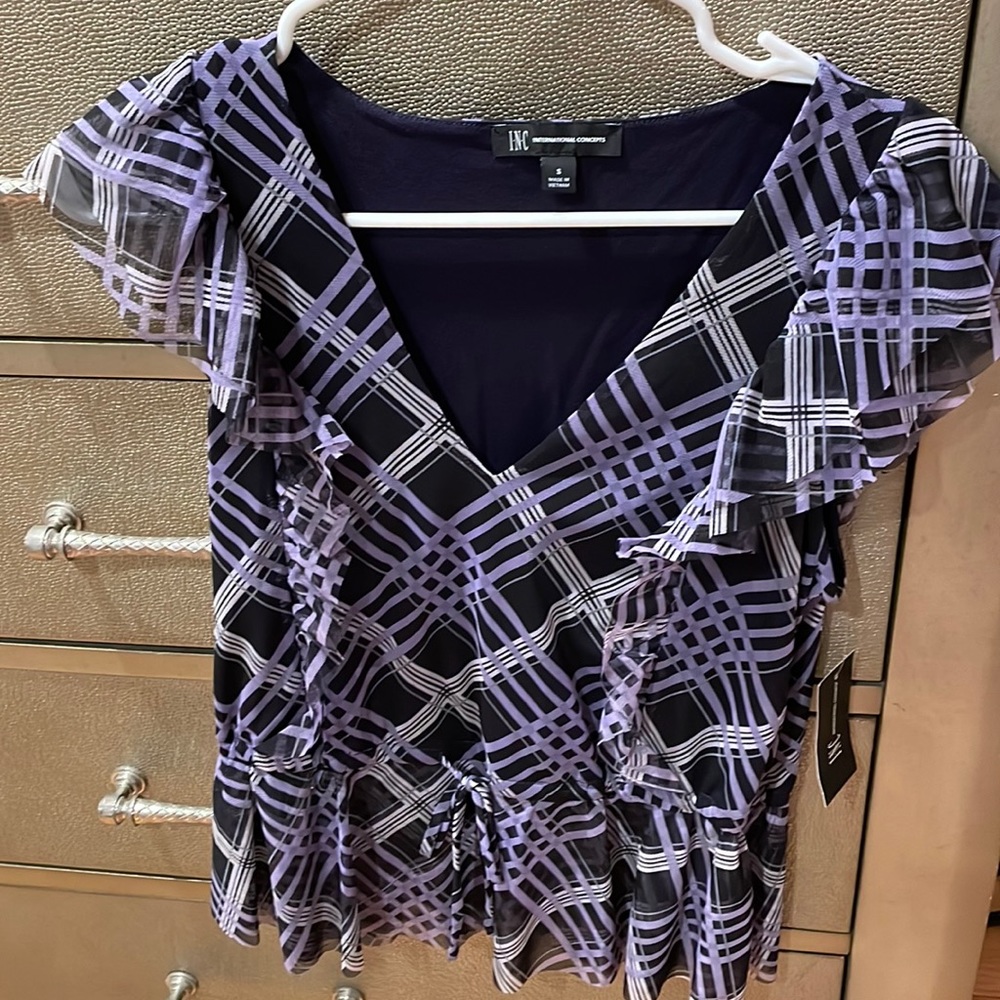 Brand new purple ruffle blouse. Never worn. New with tags.